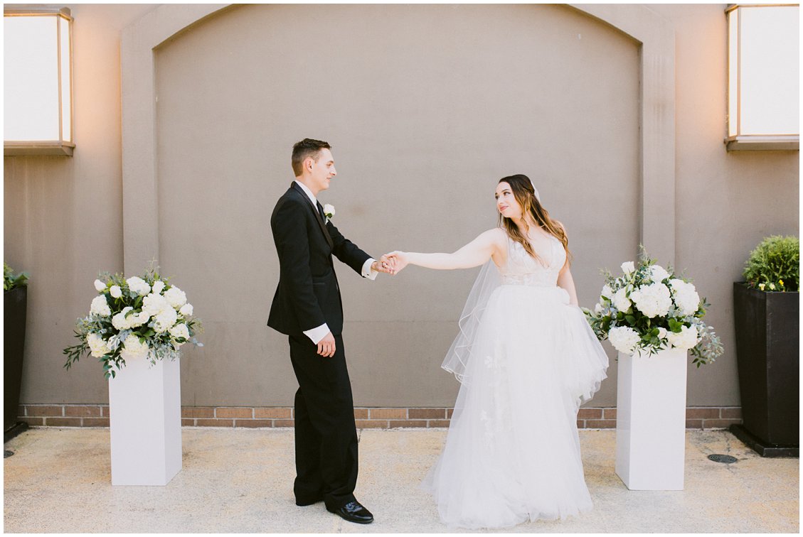 Modern & elegant bride and groom portraits with white pillar flowers and a couture wedding dress - captured by Pattengale Photography
