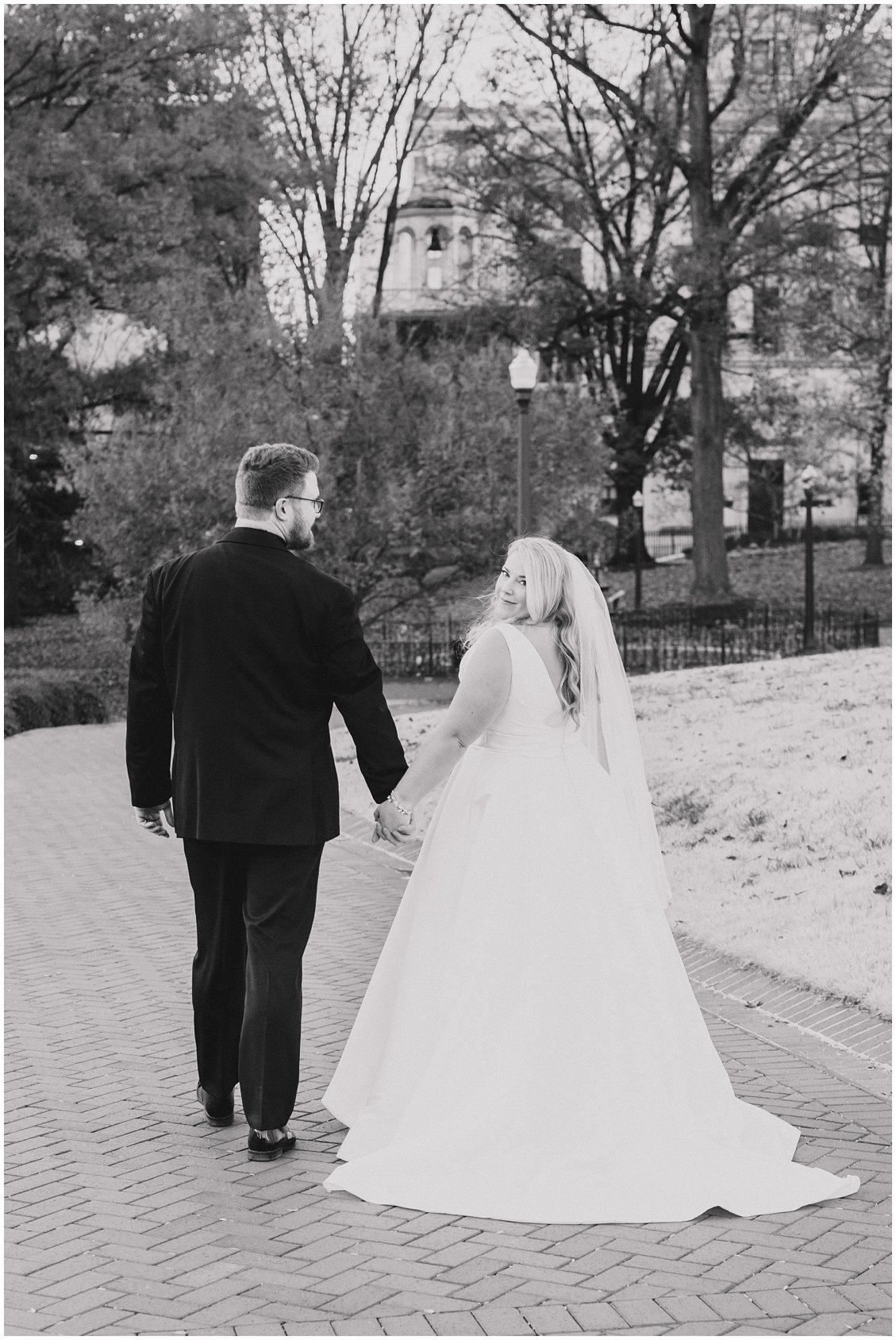 Black & White romantic photo of Bride and Groom in downtown Richmond, Virginia captured by Tara & Stephen - a husband and wife photography team